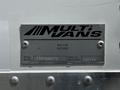 A metallic plaque on a vehicle displaying the text MultiVans Bolton Ontario with model number 15AC096078 and serial number 100778