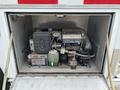A 1994 GMC Vandura 3500 with its engine compartment open showing a Honda generator and various components inside