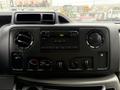 Dashboard of a 2019 Ford Econoline featuring a radio unit with buttons and knobs for climate control and audio settings