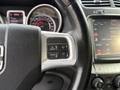 Close-up of a 2013 Dodge Journey steering wheel featuring control buttons for on off cancel and resume next to a digital display screen