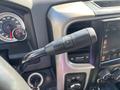 Close-up of a RAM 5500 gear shift lever featuring buttons for gear selection and cruise control functions