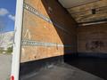 A 2014 Hino 195 truck with an empty cargo area featuring wooden walls and metal track for securing cargo