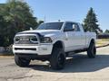 A white 2018 RAM 3500 truck with a chrome grille and black wheels parked on a driveway
