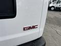 2022 GMC Savana van with a shiny red GMC emblem on the side