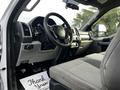 Interior of a 2017 Ford F-550 featuring a driver's seat steering wheel dashboard and control panel with a thank you note on the floor