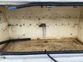 A 2015 Ford F-550 truck bed with a dirty and stained interior showing signs of wear and rust