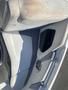 A white and gray boat seat from a 2013 Larson 238 with a built-in cup holder and speaker in the side armrest