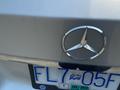 A silver 2013 Mercedes-Benz C-Class with a prominent chrome star logo and a license plate displaying FL7 05F