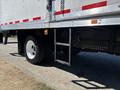 A 2022 Isuzu NQR truck showing the rear section with visible wheels and a side ladder attached to the chassis