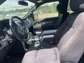 Interior view of a 2014 Ford F-150 showing the driver's seat and dashboard with a steering wheel and gear shifter