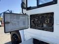 Close-up of an open electrical panel on a 2013 International CE300 revealing various fuses and wiring connections inside