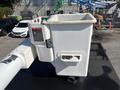 A white bucket attached to a 2019 Freightliner M2 106 vehicle used for maintenance or utility tasks
