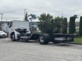 A 2020 Lion Lion6 truck with a white cab and exposed chassis parked in a lot the truck has large wheels and a minimalist design
