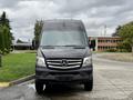 A black 2017 Mercedes-Benz Sprinter van seen from the front with a prominent Mercedes-Benz logo on the grille