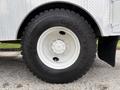 The image shows a close-up of a Goodyear tire on a white rim mounted on a 2005 Freightliner M2 106 truck