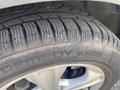 Close-up of a tire from a 2015 Ford Escape showing the tread pattern and brand name Remedy WRG5