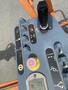Control panel of a 2009 JLG E300AJP including joystick and various buttons for operation and safety features