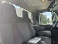 Interior view of a 2012 International 7300 Workstar featuring three broad seats with a central armrest and detailed stitching