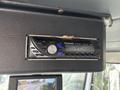 A Panasonic car stereo installed in a 2011 Autocar Xpeditor with buttons for volume tuning and display showing the word ADJUST