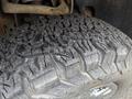 Close-up of a rugged tire tread on a 2014 Ford F-150 showing deep grooves and texture designed for traction on various surfaces