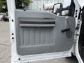 Interior door panel of a 2015 Ford F-350 SD featuring a textured gray design with a handle and vents