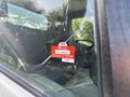 A red inspection sticker on the window of a 2018 Hino 195 truck indicating a certificate of approval with the number GH 84118 and the year 2026