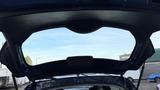 Inside the rear of a 2019 Nissan Kicks with the trunk open revealing the cargo area and back window