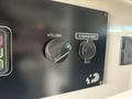 Close-up of a control panel featuring a volume knob and a 12 volts power outlet in a 2020 Mercedes-Benz Sprinter 2500