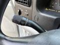 Close-up of the steering column of a 2006 Ford F-550 showing the turn signal and windshield wiper control lever