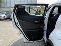 A 2021 Toyota C-HR with its driver's side door open displaying the interior door panel and controls