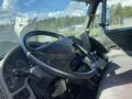 Interior view of a 2014 International 7400 showing the steering wheel dashboard and controls