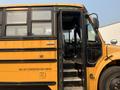 A yellow 2007 Freightliner B2 school bus with an open door showing the driver’s seat and steering wheel inside