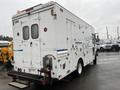 A 2012 Workhorse W62 vehicle with a white exterior features multiple doors and compartments on the sides and back with visible ventilation grids and a step at the rear