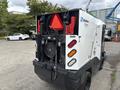 A 2019 Madvac LS175 litter vacuum with a compact design and various control panels on the rear side showcasing lights and a detachable collection container