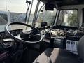 Interior view of a 2011 Autocar Xpeditor with a steering wheel control panel featuring gauges levers and various buttons