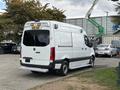 A 2020 Mercedes-Benz Sprinter 2500 van in white with black accents and multiple roof lights is parked with the rear view visible