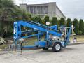 A blue 2016 Genie TZ-34/20 articulating boom lift designed for aerial work featuring extendable arms and a platform for lifting operators at height