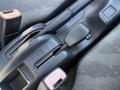 A close-up of a gearshift area in a 2008 Suzuki Carry showing the shift lever and control switches for four-wheel drive and other settings