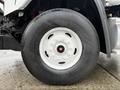 Close-up of a 2016 Freightliner 108SD truck tire showing the white rim and black tire tread