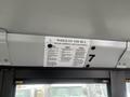 A 2007 Freightliner B2 interior view showing a sign on the ceiling with instructions for passengers while on the bus