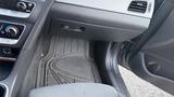 The interior of a 2018 Hyundai Sonata showing the floor mat controls and dashboard area with knobs and buttons