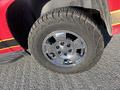 Close-up of a chrome wheel and tire from a 2011 Chevrolet Avalanche showcasing a rugged tread pattern