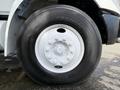 A close-up view of a large tire from a 2011 International 4300 truck showing the white steel wheel and Bridgestone tire with visible tread patterns