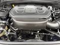 Engine compartment of a 2019 Jeep Grand Cherokee displaying a V8 engine with various components and hoses interconnected