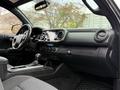 Interior view of a 2016 Toyota Tacoma showing the dashboard steering wheel and center console with a display screen and controls
