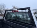 A black mesh truck rack on the rear of a 2017 GMC Sierra 3500HD with the word BACKRACK displayed at the top