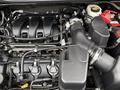 Engine compartment of a 2019 Ford Explorer showing the intake manifold fuel injectors and various hoses and components
