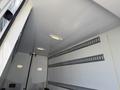 A 2016 Mercedes-Benz Sprinter with a spacious interior featuring overhead lights and vertical tracks on the walls for securing cargo