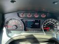 Instrument cluster of a 2014 Ford F-150 showing gauges for fuel economy trip settings and truck apps along with odometer reading