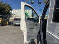 A 2017 Ford Transit-350 van with the driver's side door open showcasing the interior design and controls